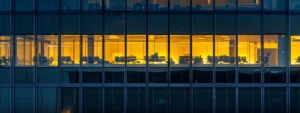 a gleaming high-rise office building reflects a vibrant urban skyline, showcasing pristine windows that highlight the transformative impact of a professional window cleaning service.