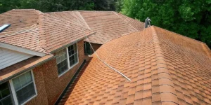 Professional soft washing a roof on a Long Island home