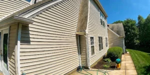Professional soft washing a Long Island home exterior