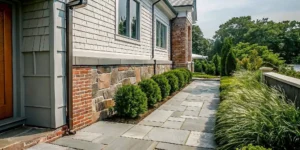 Professional soft washing masonry cleaning on a Long Island brick and stone home exterior
