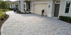 Professional paver sealing services enhancing the color and durability of a residential driveway.