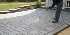 Cleaning pavers filled with polymeric sand before sealing.