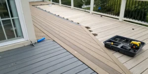 New composite boards being installed, a key part of the cost to resurface a deck.